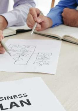 personas sentadas evaluando y gestionando su negocio